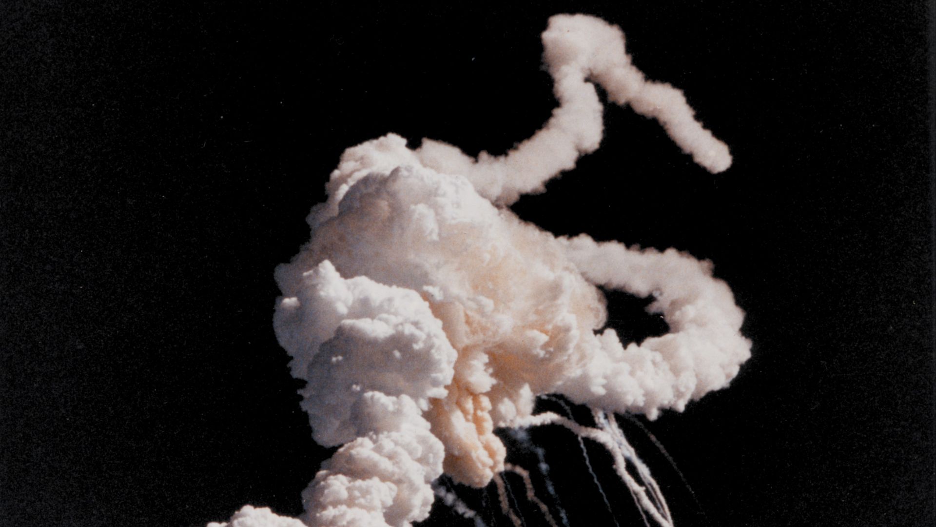 Short Description: Space Shuttle Challenger explodes shortly after take-off.
Full Description: On January 28, 1986, the Challenger space shuttle and her seven-member crew were lost when a ruptured O-ring in the right solid rocket booster caused an explosi
