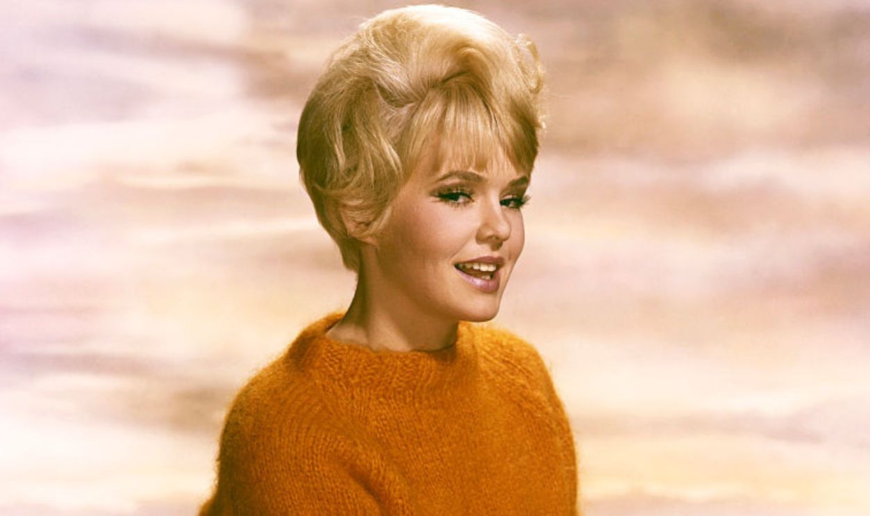 Joey Heatherton poses on ship's wheel circa 1964