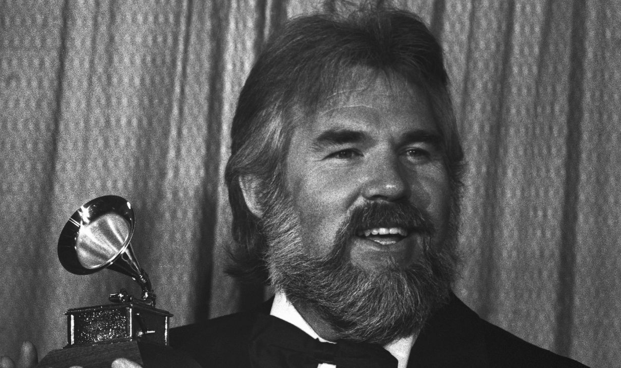 Kenny Rogers holds his Grammy Award during ceremonies at the 20th annual edition of the awards 2/23. The Best Country Vocal Performance grammy by a male went to Kenny Rogers for his song
