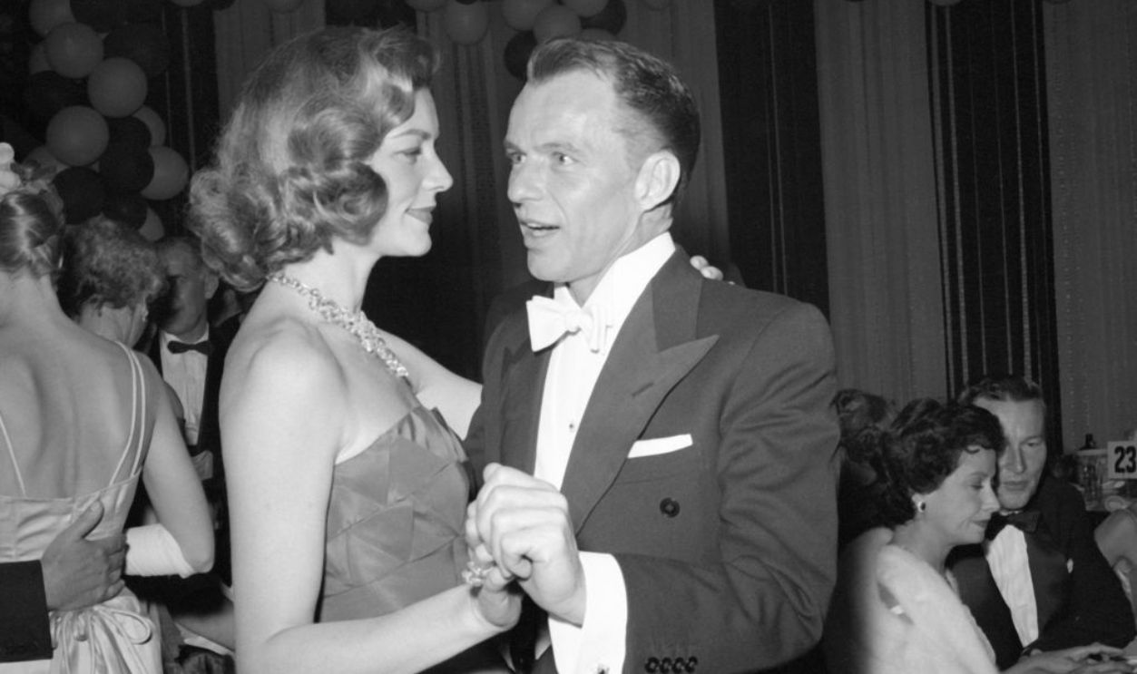 Frank Sinatra and Lauren Bacall dancing together at Hollywood event
