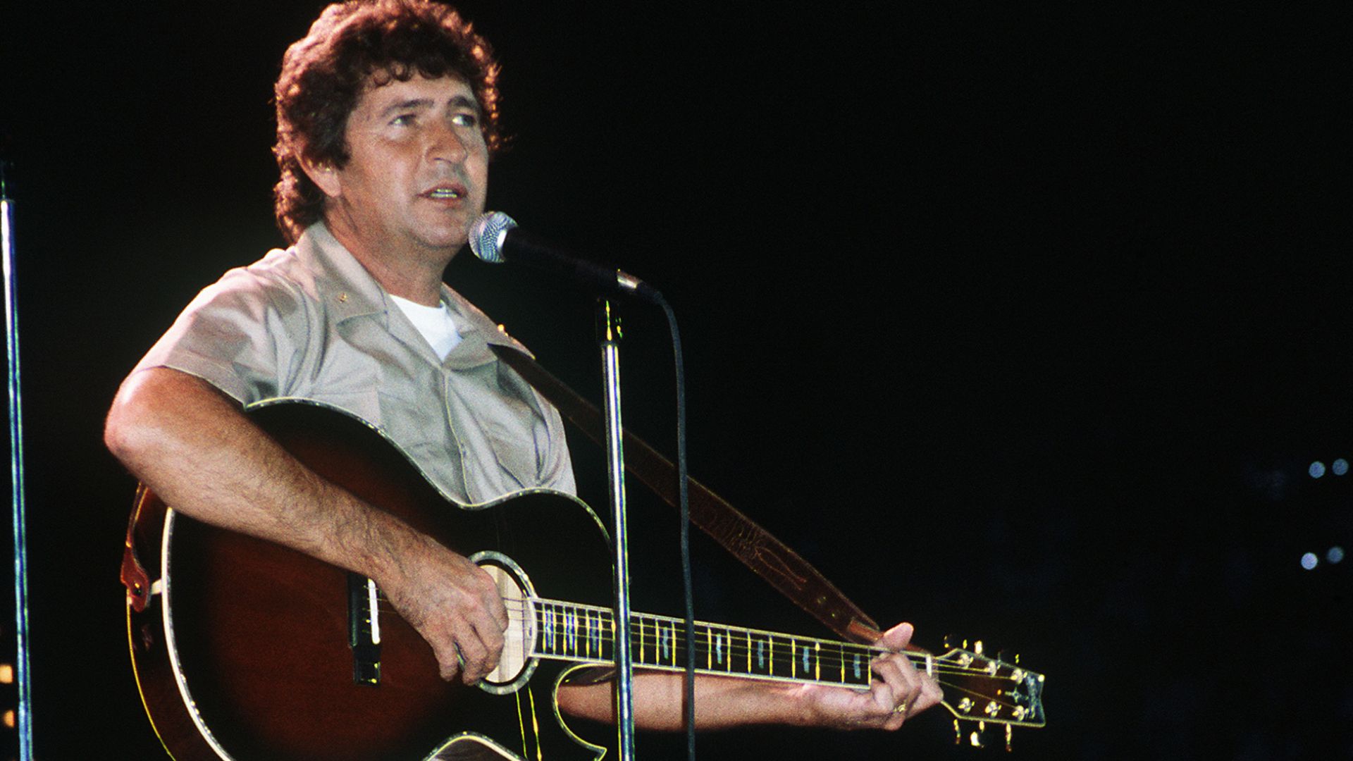 Country western music singer Mac Davis performs in a United Service Organizations (USO) show in the Pensacola Civic Center during the celebration of the 75th anniversary of naval aviation. VIRIN DN-ST-87-03194