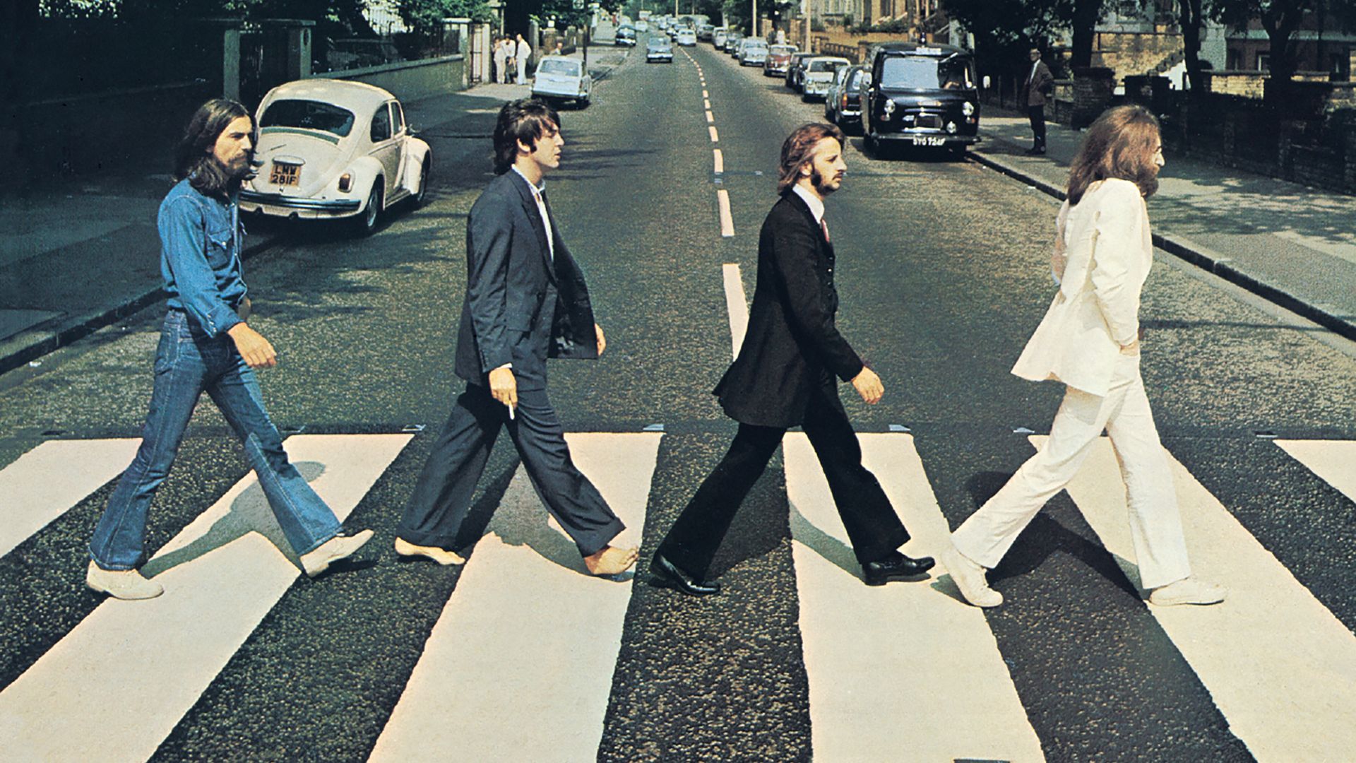 Front cover of Abbey Road by The Beatles. The view really is Abbey Road, London, NW8 looking north.  The gates of the Abbey Road Studios are behind the white VW Beetle on the left.