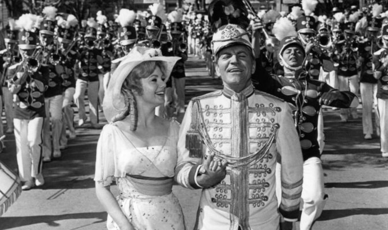 Shirley Jones and Robert Preston march to the music of 76 trombones in a scene from the film 'The Music Man', 1962.