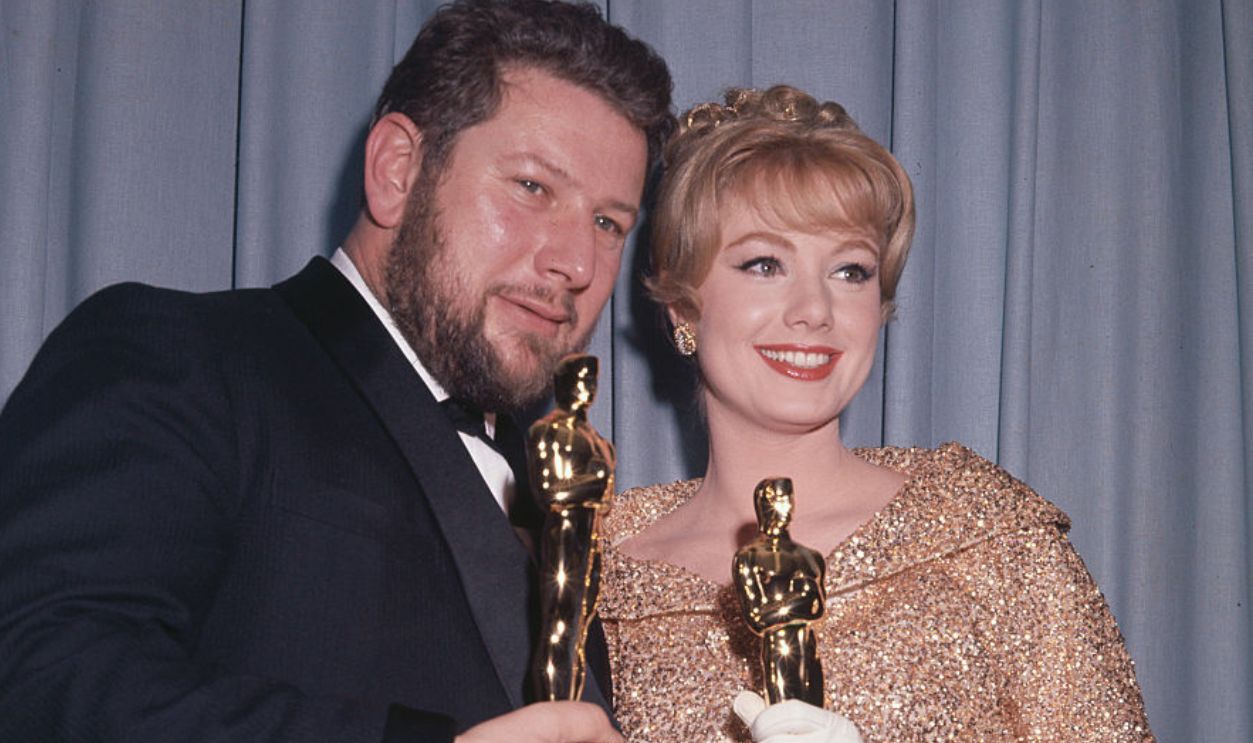 (Original Caption) Annual Academy Awards: Winners of oscar for best actress and actor in a supporting role, Peter Ustinov and Shirley Jones hold oscars.