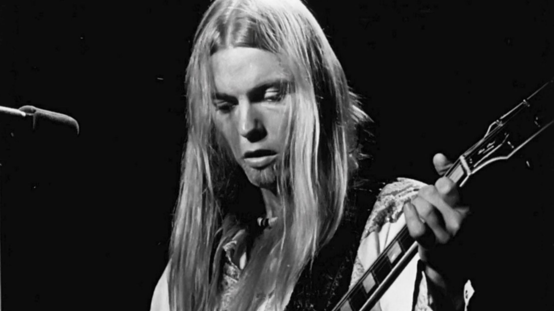 Photo of Gregg Allman performing with the Allman Brothers Band.