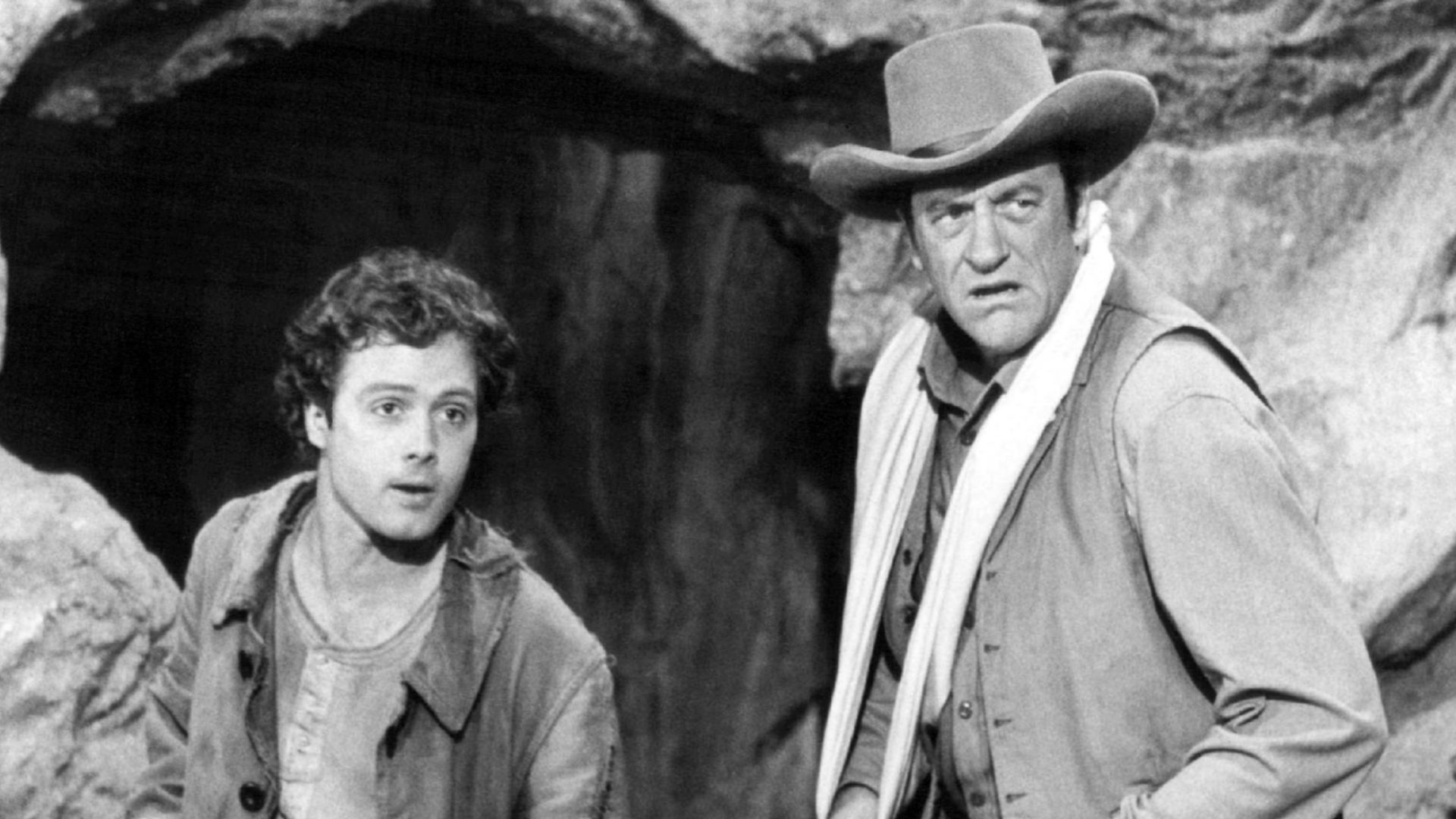 Photo from the television program Gunsmoke.  Pictured are guest star Dennis Redfield (left) as Lem and James Arness as Matt Dillon.