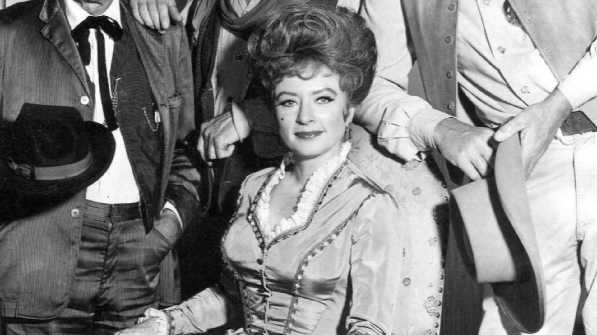 Main cast photo from the television program Gunsmoke in 1967.  Standing, from right: James Arness as Marshall Matt Dillon, Ken Curtis as Festus Hagen, and Milburn Stone as