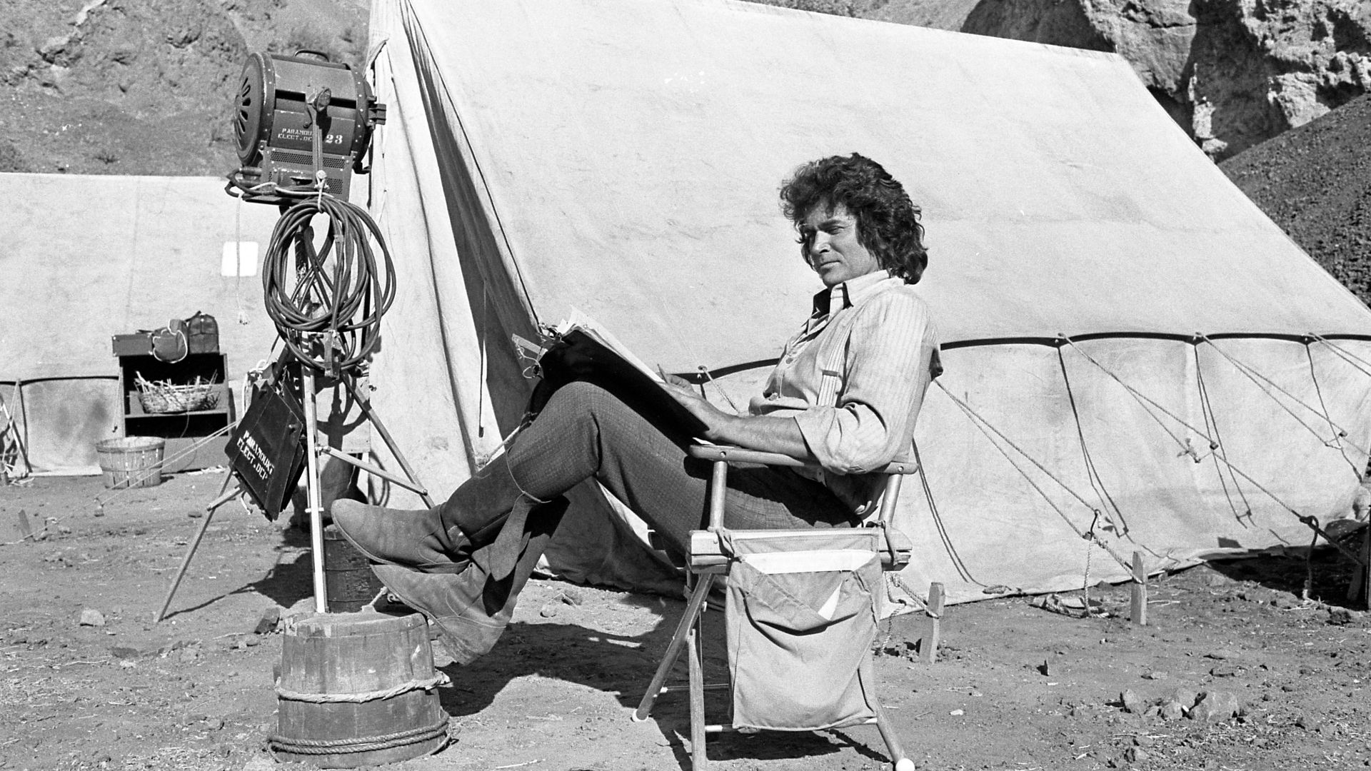 WINNING THE WEST—Actor, writer, director, producer Michael Landon takes break during filming of Little House on the Prairie to read script.