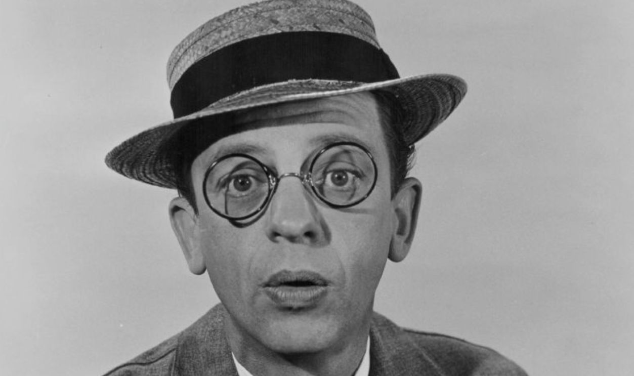 Portrait of actor and comedian Don Knotts, wearing a straw hat and bow tie, circa 1950-1960.