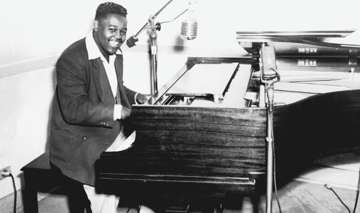 R&B musician Fats Domino poses for a portrait at the piano in circa 1956.