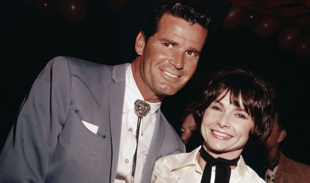 Mr And Mrs Garner Circa 1965, American actor James Garner smiles with his wife, Lois Clarke, as they wear Western gear at a party, 1960s.