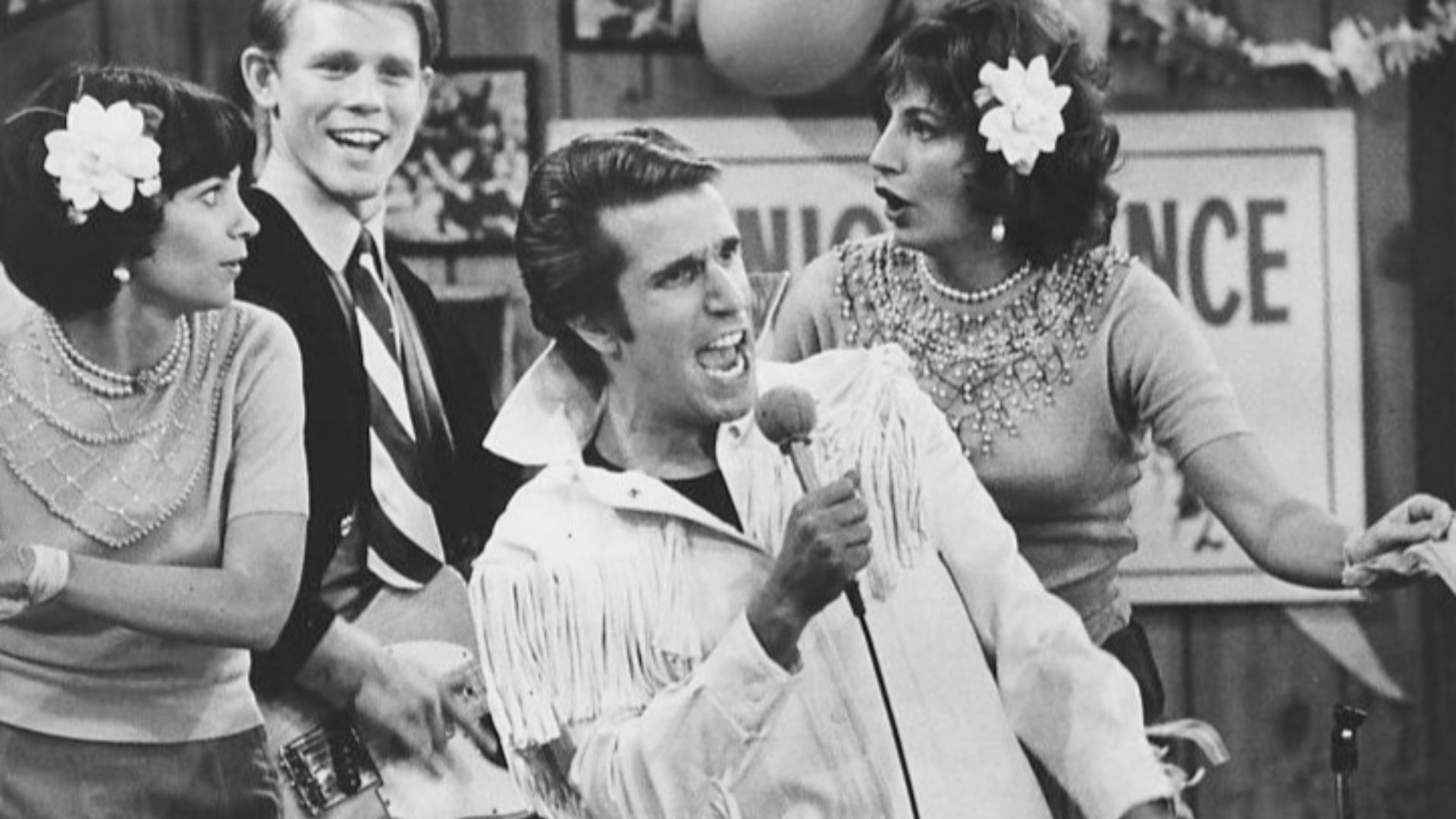 Photo from Happy Days. In this episode, The Fonz becomes a singing superstar. Pictured are Cindy Williams as Shirley Feeney, Ron Howard as Richie Cunningham, Henry Winkler as Fonzie and Penny Marshall as Laverne DiFazio.