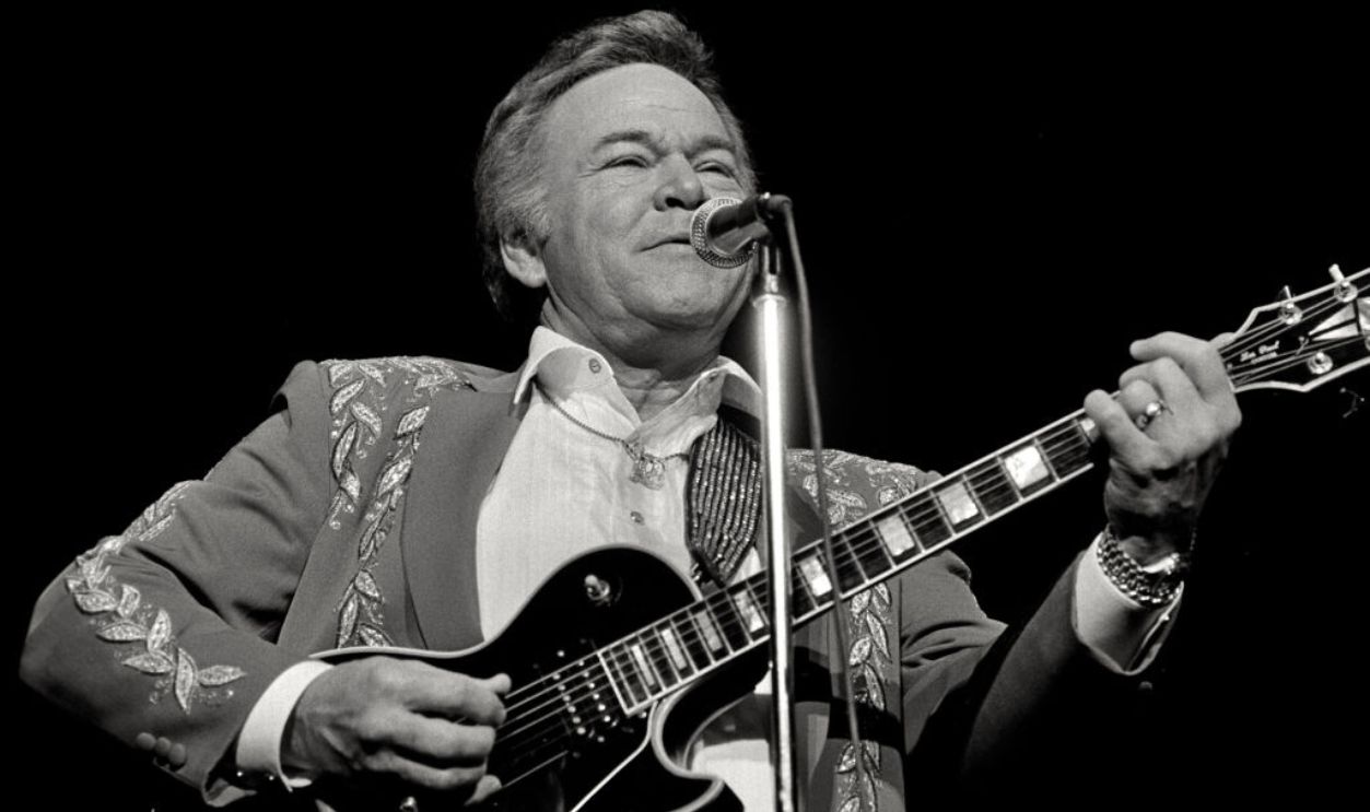 CHEYENNE, WY – JANUARY 20: Roy Linwood Clark (d. 11-15-18) sings and plays the guitar in a performance at the Cheyenne Civic Center on January 20, 1995 in Cheyenne, Wyoming. Clark became a member of the Grand Ole Opry in 1987 and was inducted into the Country Music Hall of Fame in 2009. The image was tinted by the photographer. 