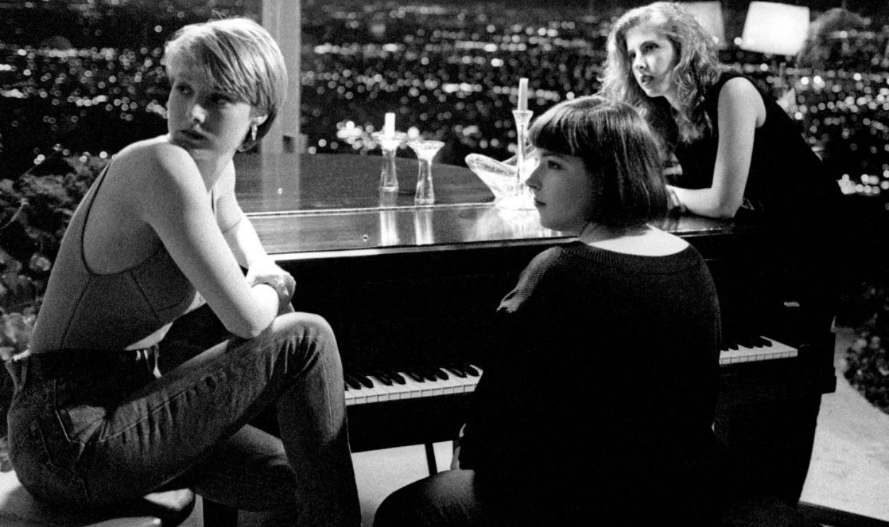LOS ANGELES, CA - CIRCA 1990: (L-R) American singer and actress Chynna Phillips, American singer and television personality Carnie Wilson and American singer and television personality Wendy Wilson, of the American pop group Wilson Phillips, sit on the set of their video of 