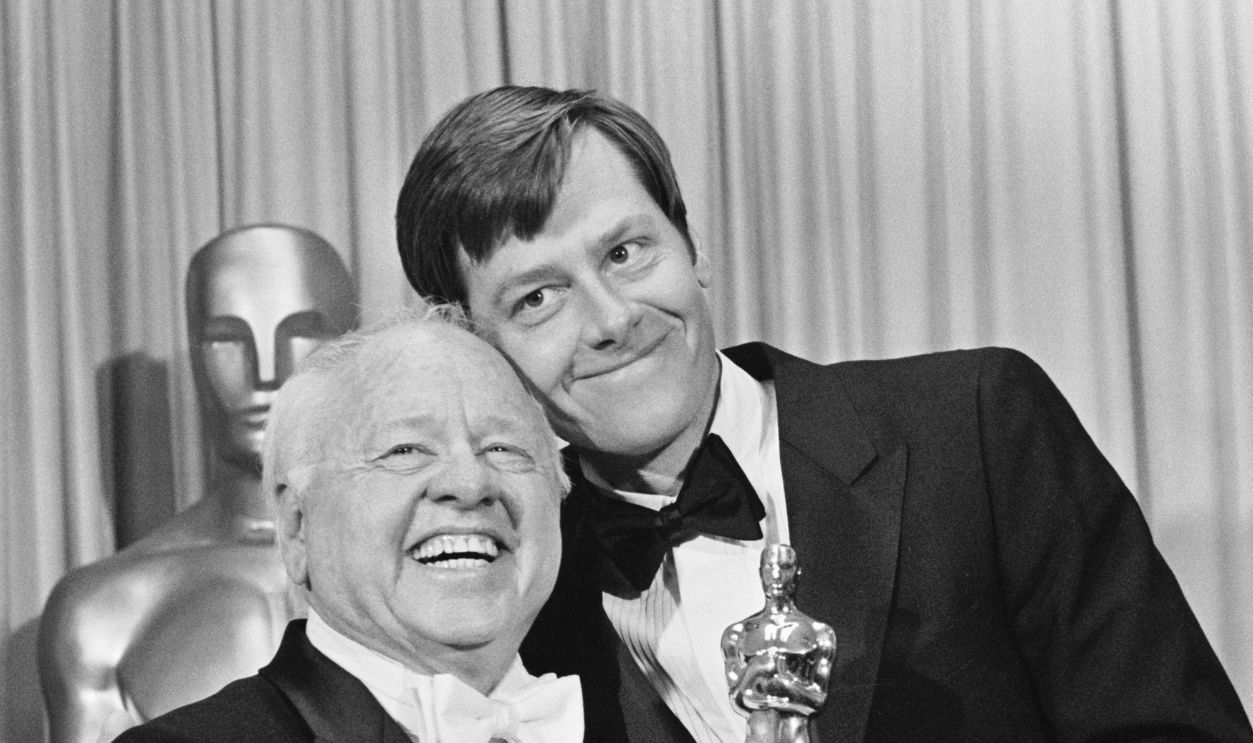 Actor Mickey Rooney (L), is all abeam as he is congratulated by his son Tim, after the famous actor received a Special Honorary Award at the 55th Annual Academy Award presentation at the Music Center.