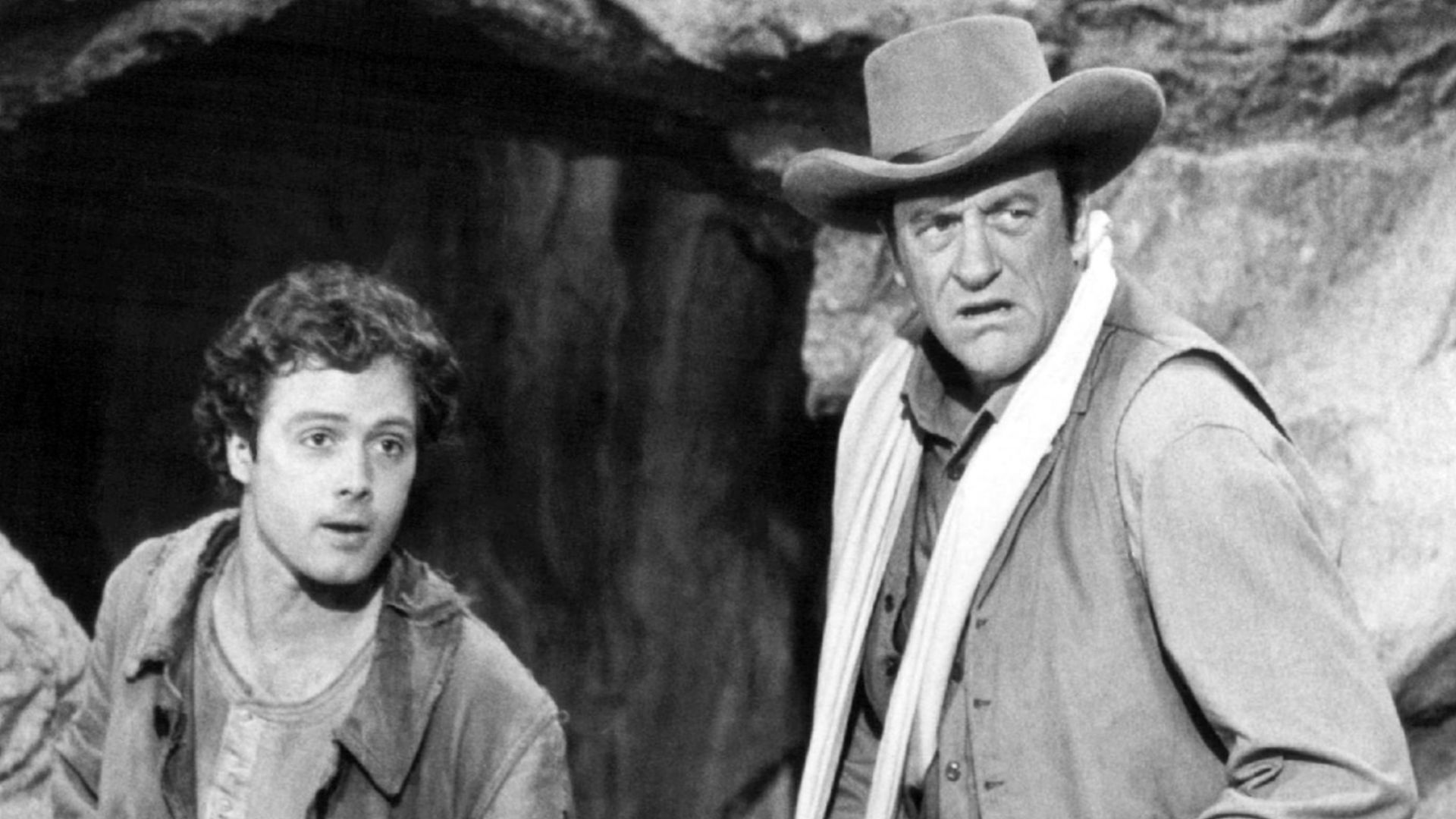 Photo from the television program Gunsmoke.  Pictured are guest star Dennis Redfield (left) as Lem and James Arness as Matt Dillon.