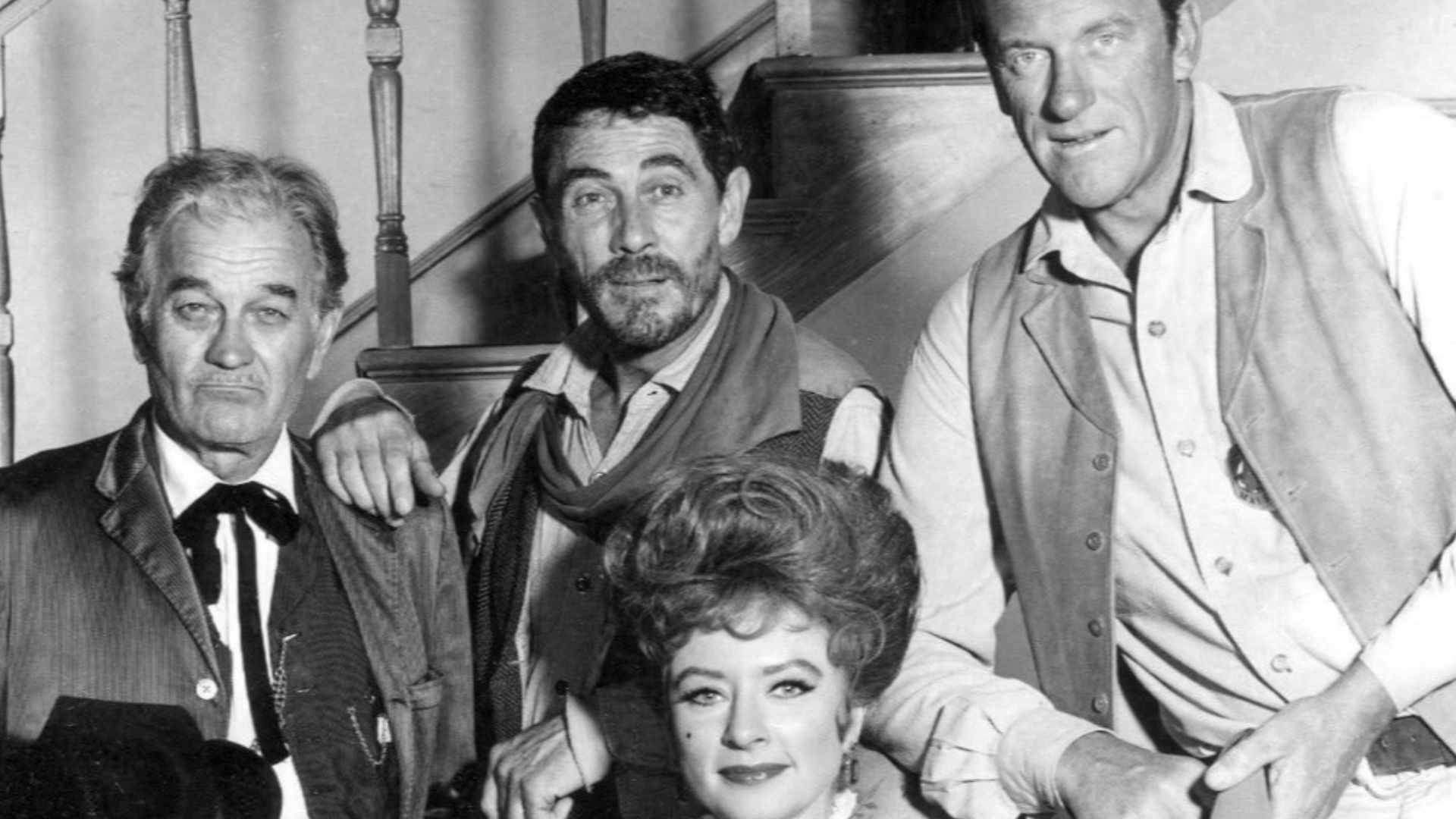 Main cast photo from the television program Gunsmoke in 1967.  Standing, from right: James Arness as Marshall Matt Dillon, Ken Curtis as Festus Hagen, and Milburn Stone as