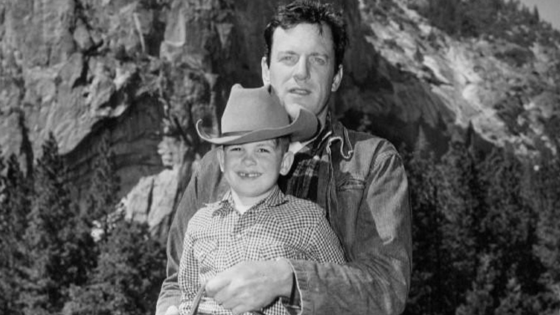 Publicity photo of James Arness on horseback with his son, Rolf.