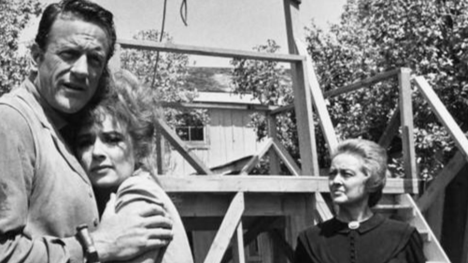 Photo from the television program Gunsmoke.  Pictured are James Arness (Matt Dillon), Amanda Blake (Miss Kitty) and guest star Bette Davis.