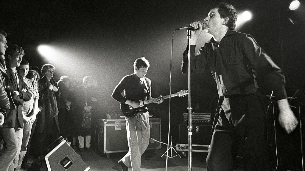  Joy Division performing live in Rotterdam, Bernard Sumner (left) & Ian Curtis
