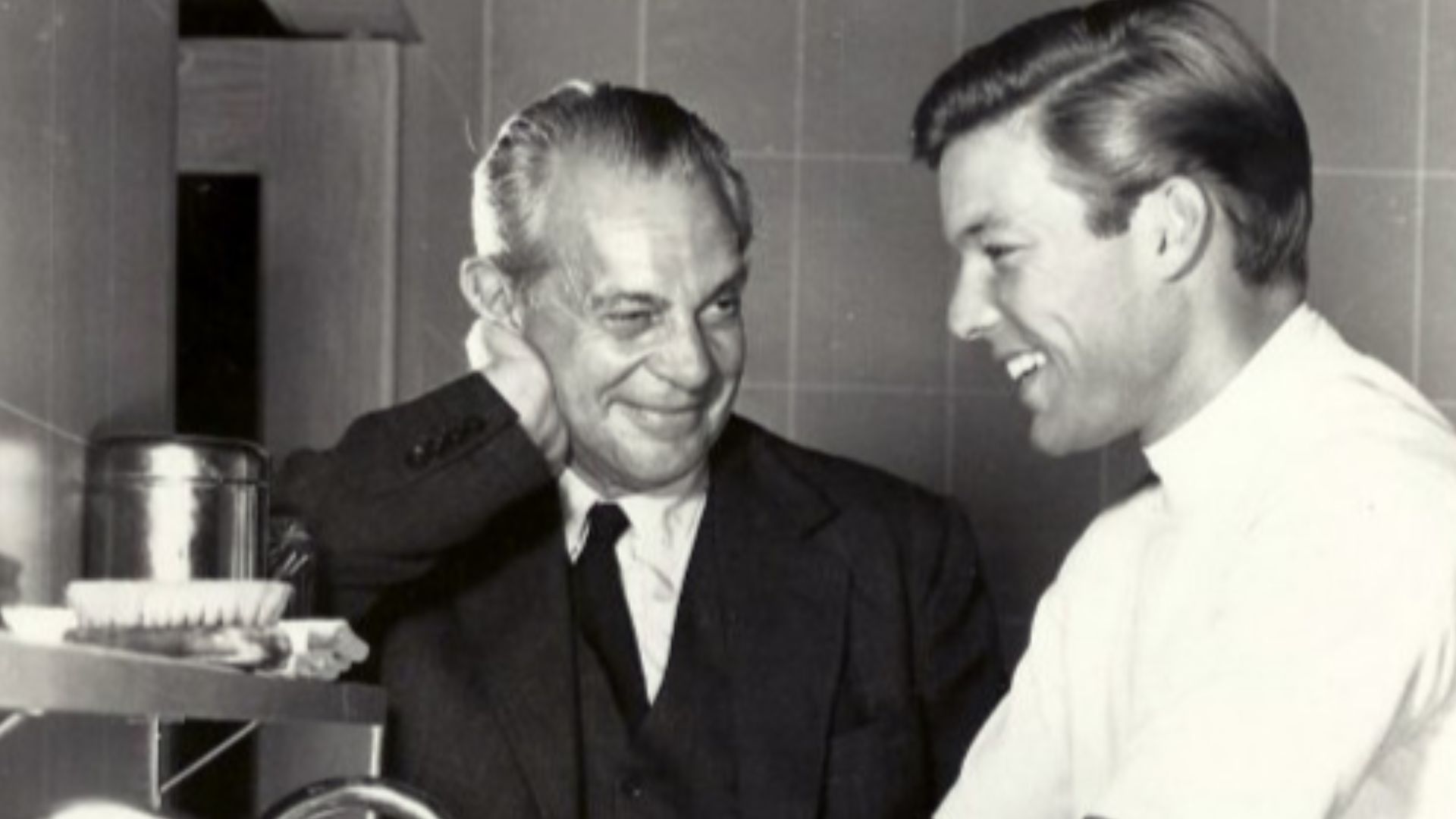 Publicity photo announcing the premiere of the television program Dr. Kildare.  Raymond Massey is Dr. Gillespie and Richard Chamberlain is Dr. Kildare, shown scrubbing up.