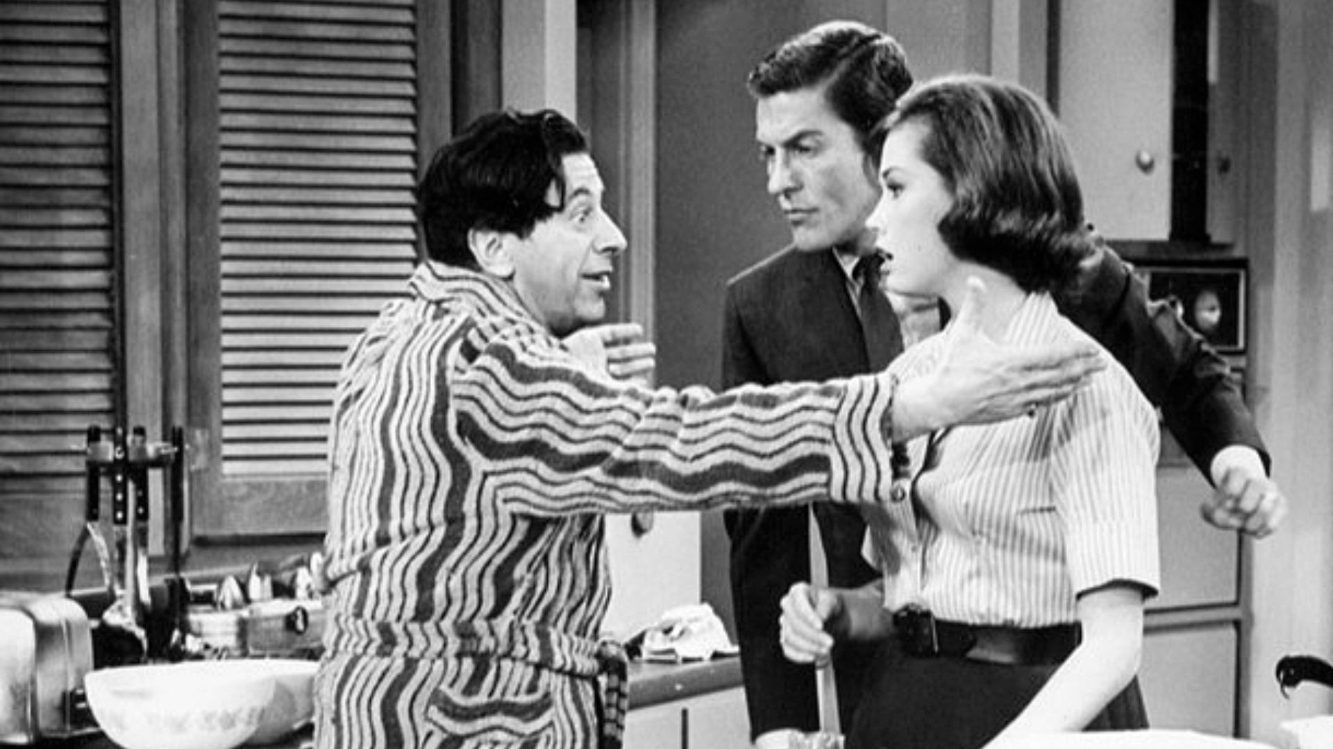 Publicity photo from The Dick Van Dyke Show. Pictured are Buddy (Morey Amsterdam) and Laura (Mary Tyler Moore) and Rob (Dick Van Dyke) Petrie. When Buddy's wife, Pickles, goes out of town, Buddy becomes the Petrie's house guest.