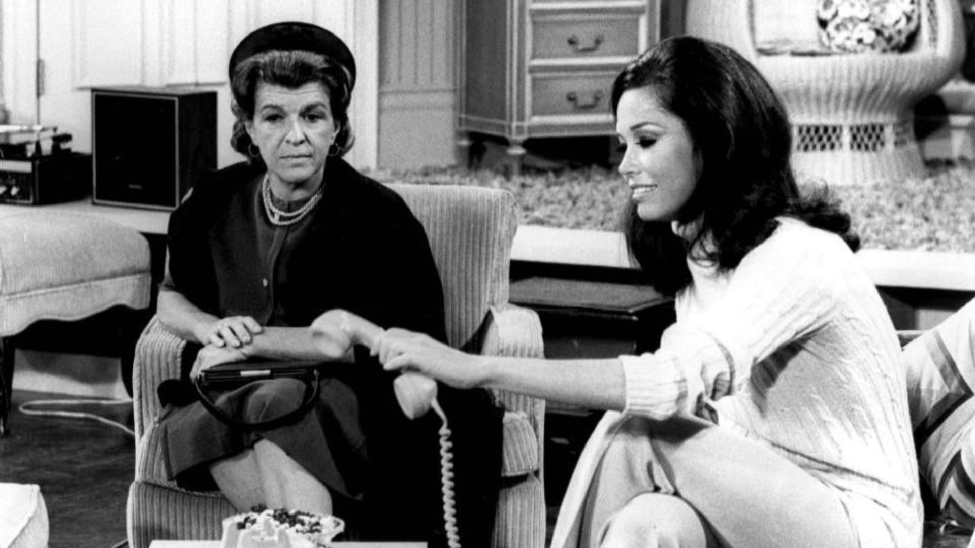 Photo of Nancy Walker as Ida Morgenstern and Mary Tyler Moore as Mary Richards from The Mary Tyler Moore Show.  In this episode, Ida, the mother of Rhoda, arrives in Minneapolis unannounced.  She has nowhere to stay when her daughter refuses to see her, s