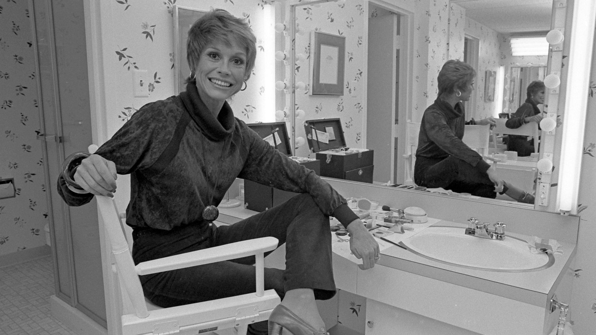 Actress Mary Tyler Moore sitting before dressing table