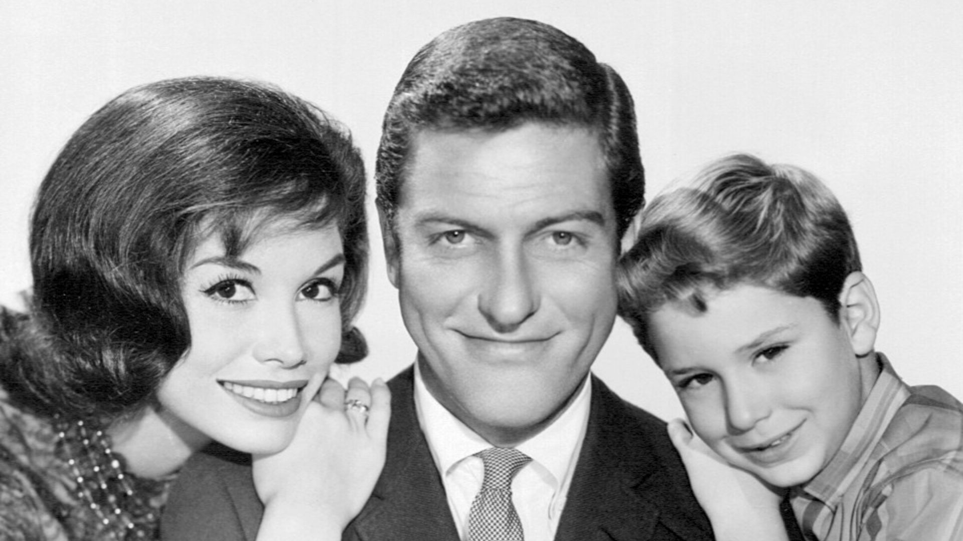 Photo of the Petrie family from the television program The Dick Van Dyke Show. From left-Mary Tyler Moore (Laura Petrie), Dick Van Dyke (Rob Petrie), Larry Mathews (Richie Petrie).
