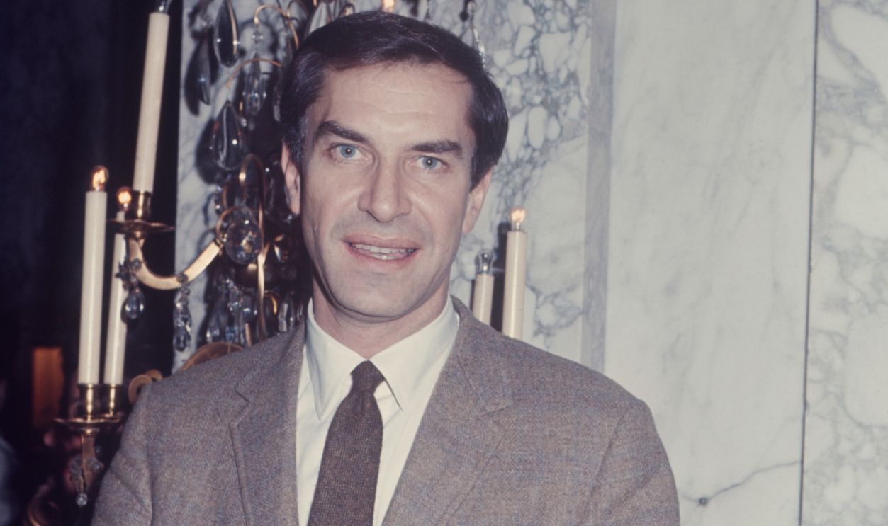 Martin Landau at the Plaza Hotel wearing a brown suit and tie; circa 1970; New York.