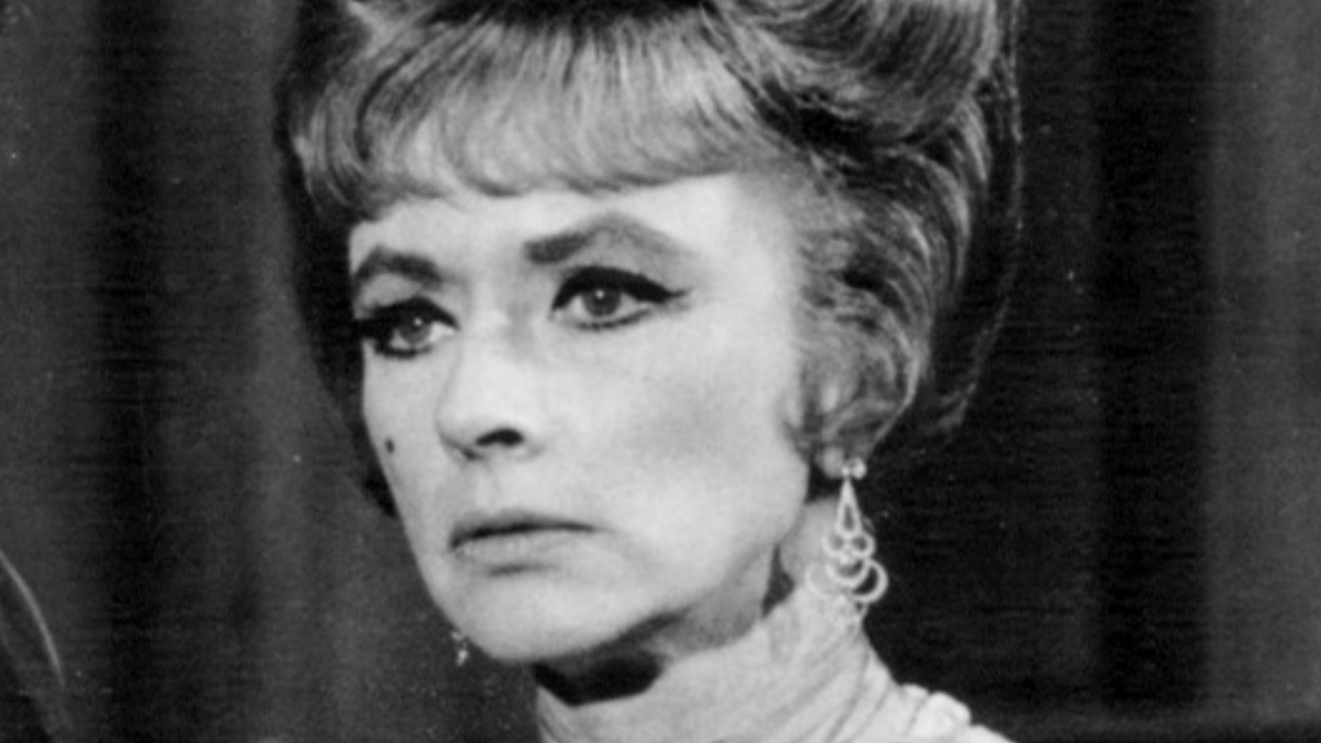 Photo of Amanda Blake as Miss Kitty and Pernell Roberts guest-starring as a hired gunfighter from the television series Gunsmoke.