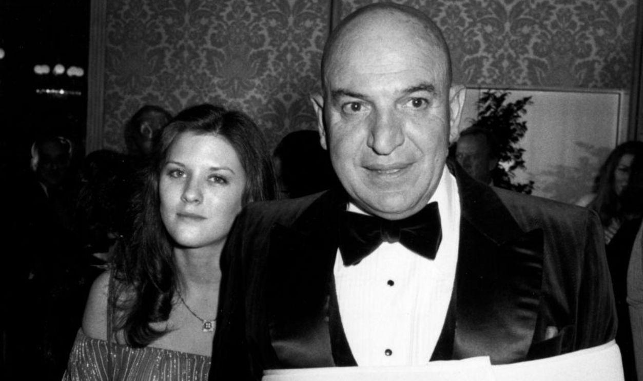 BEVERLY HILLS, CA - JANUARY 20: Actor Telly Savalas and wife Julie Hovland attend 85th Birthday Party for George Burns on January 20, 1981 at the Beverly Hilton Hotel in Beverly Hills, California.