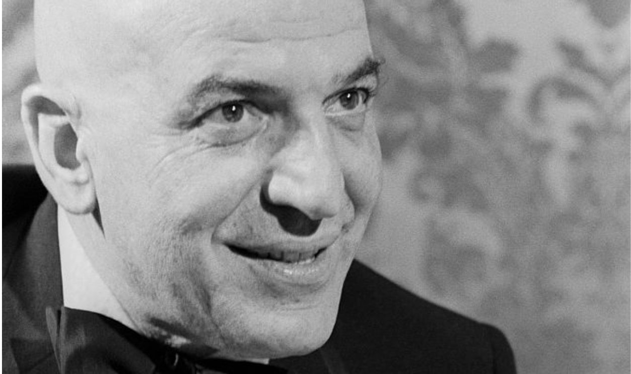 Telly Savalas close-up wearing a tux; circa 1970; New York.