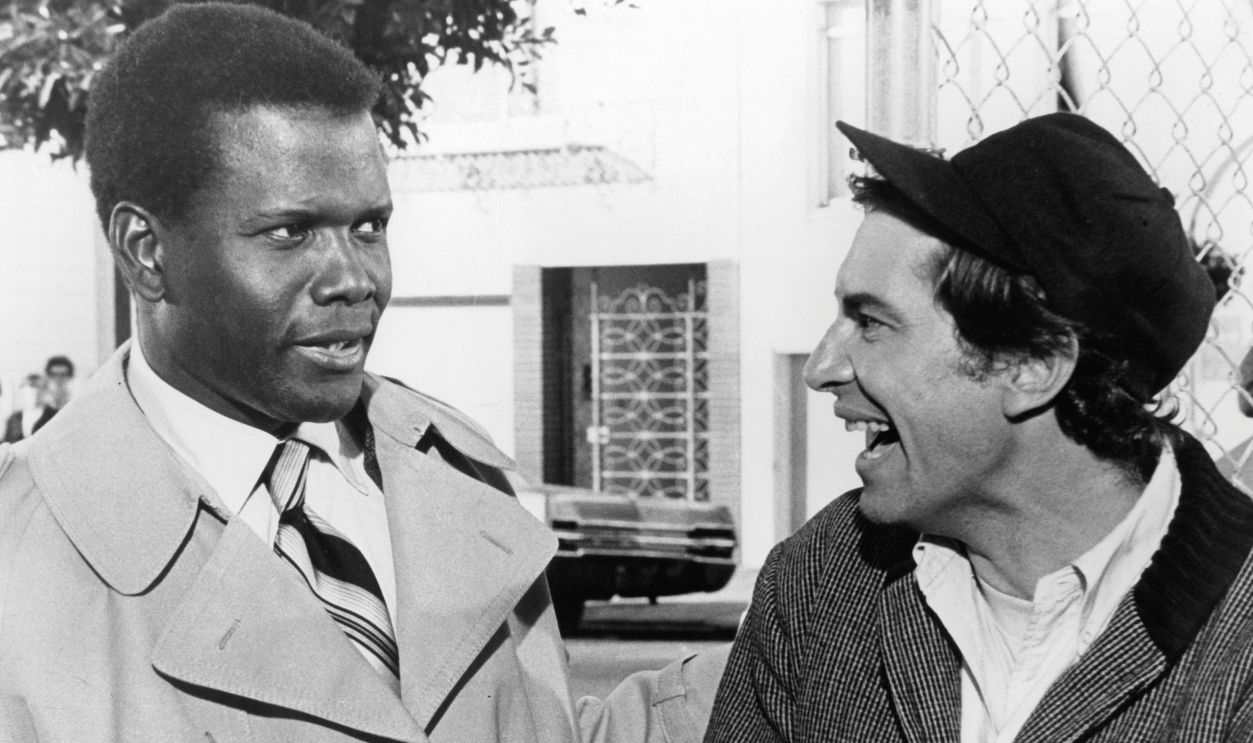 Sidney Poitier and Martin Landau enjoy a joke together in a scene from the film 'They Call Me MISTER Tibbs!', 1970.