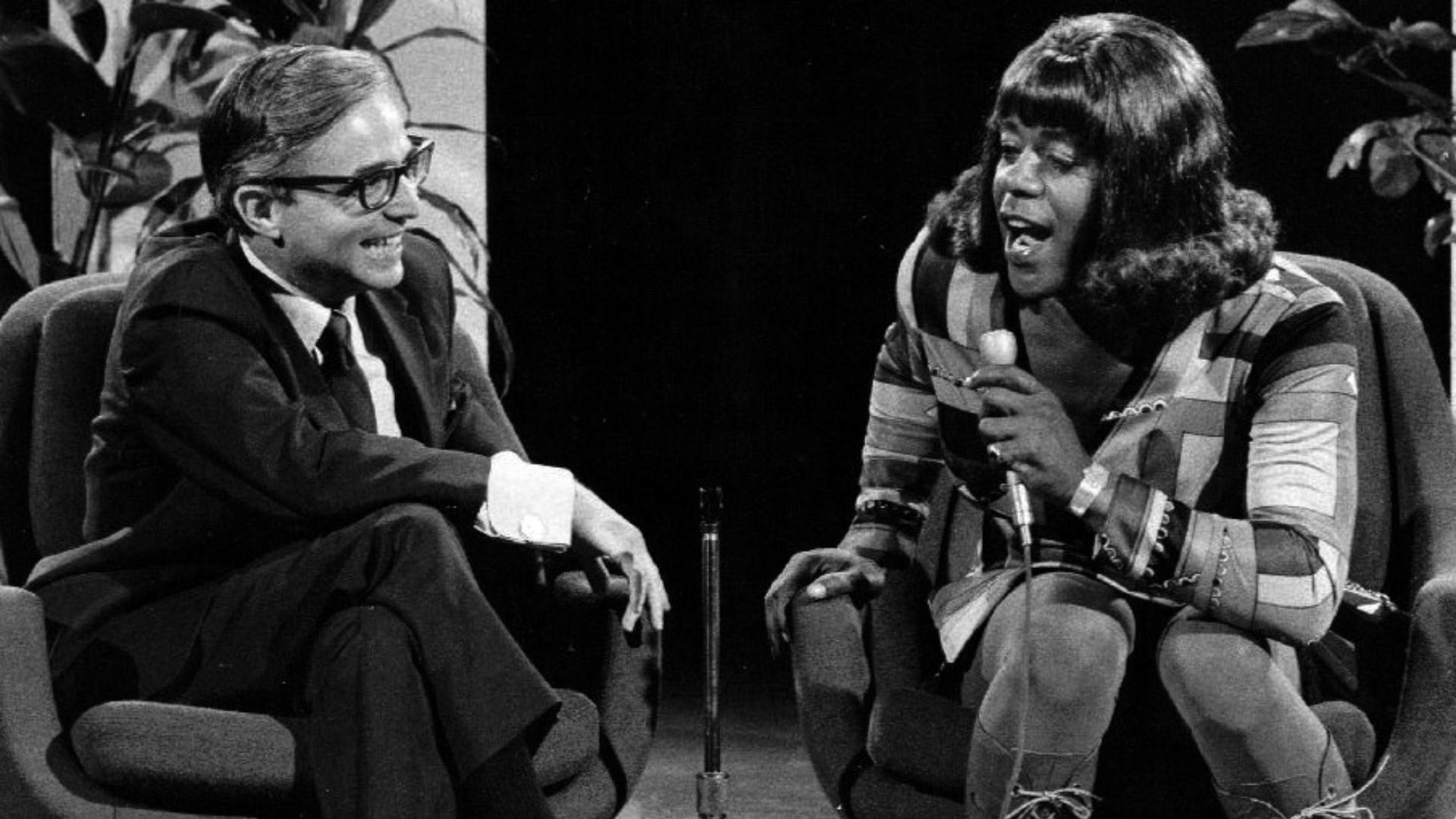 Publicity photo of Flip Wilson as Geraldine Jones from the television program The Flip Wilson Show.  Geraldine is interviewing Dr. David Reuben.