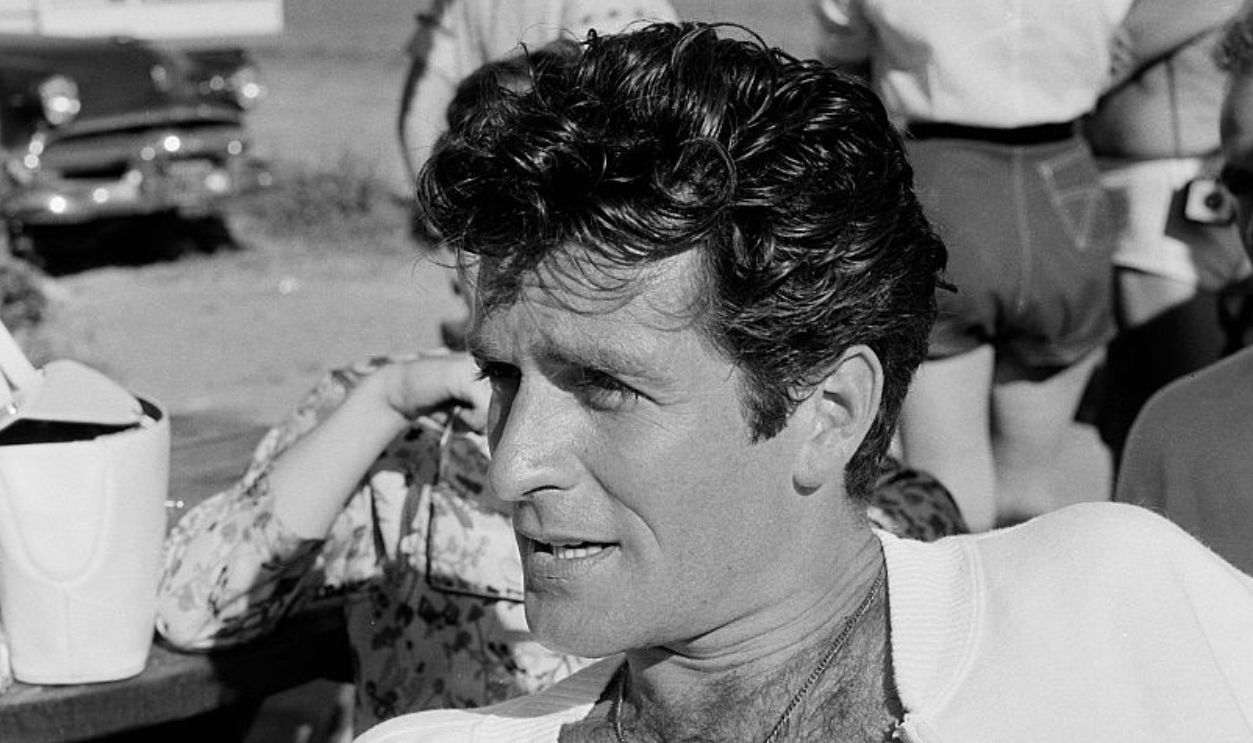 MALIBU,CALIFORNIA - JULY 15,1956: Actor Hugh O'Brian relaxes during the Thalians Beach Ball in Malibu,California. 