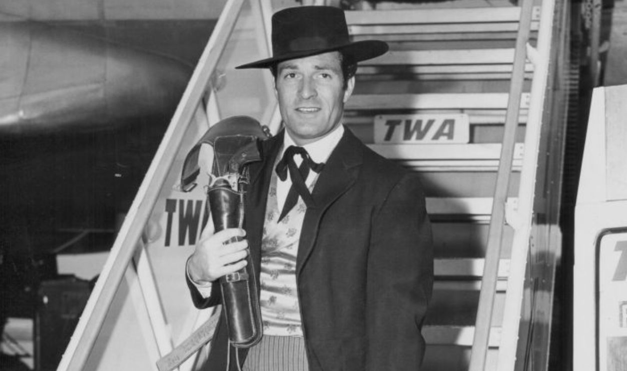 Actor Hugh O'Brian wearing his 'Wyatt Earp' costume, arriving at Idlewild Airport in New York for the Macy's Thanksgiving Parade, on a Trans World Arlines plane, circa 1955-1965.
