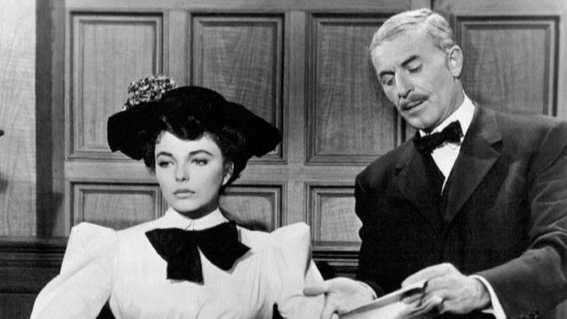 Photo of Joan Collins as Evelyn Nesbit Thaw and John Hoyt as District Attorney William Travers Jerome from the 1955 film The Girl in the Red Velvet Swing.