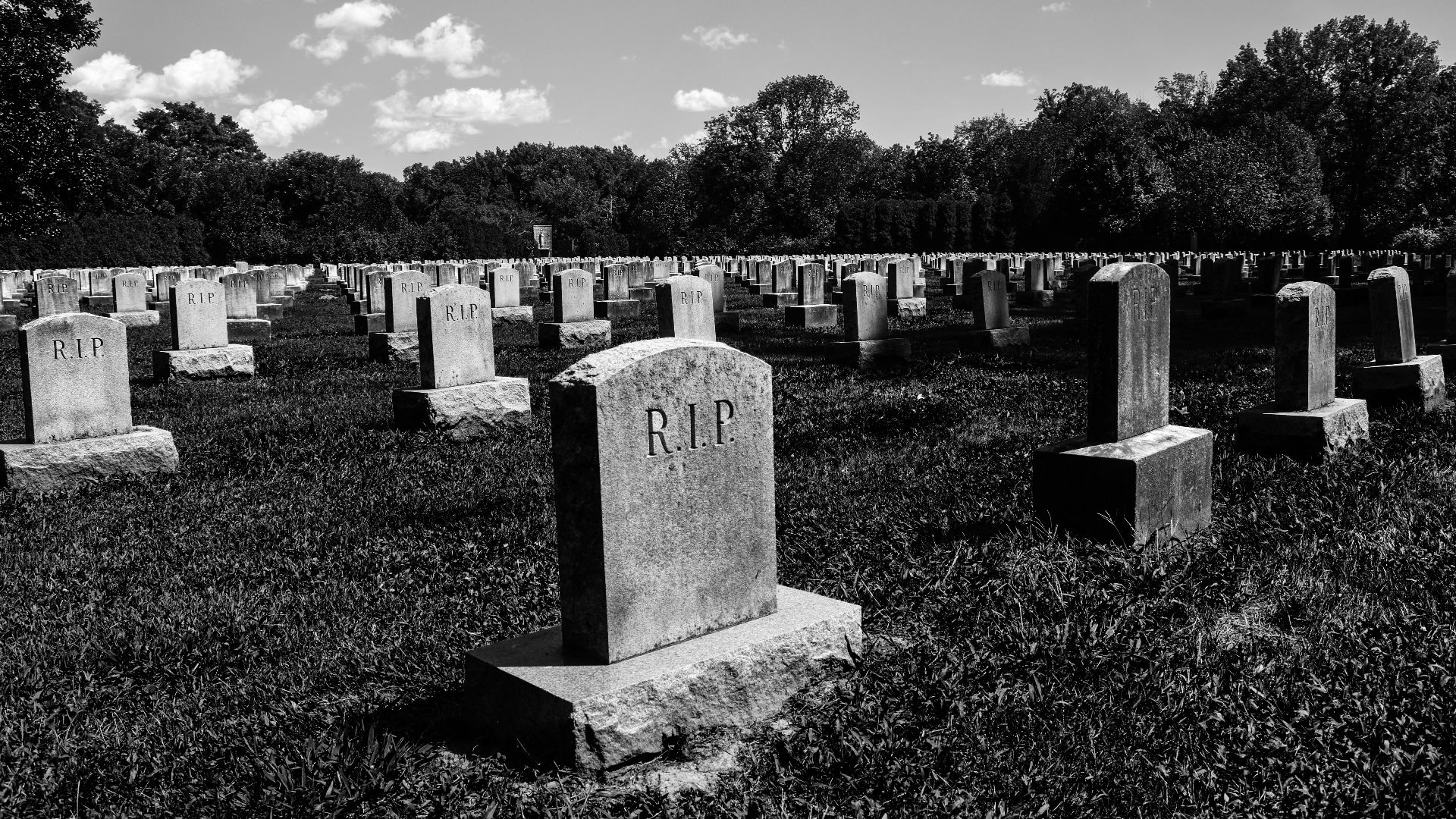 a black and white photo of a cemetery