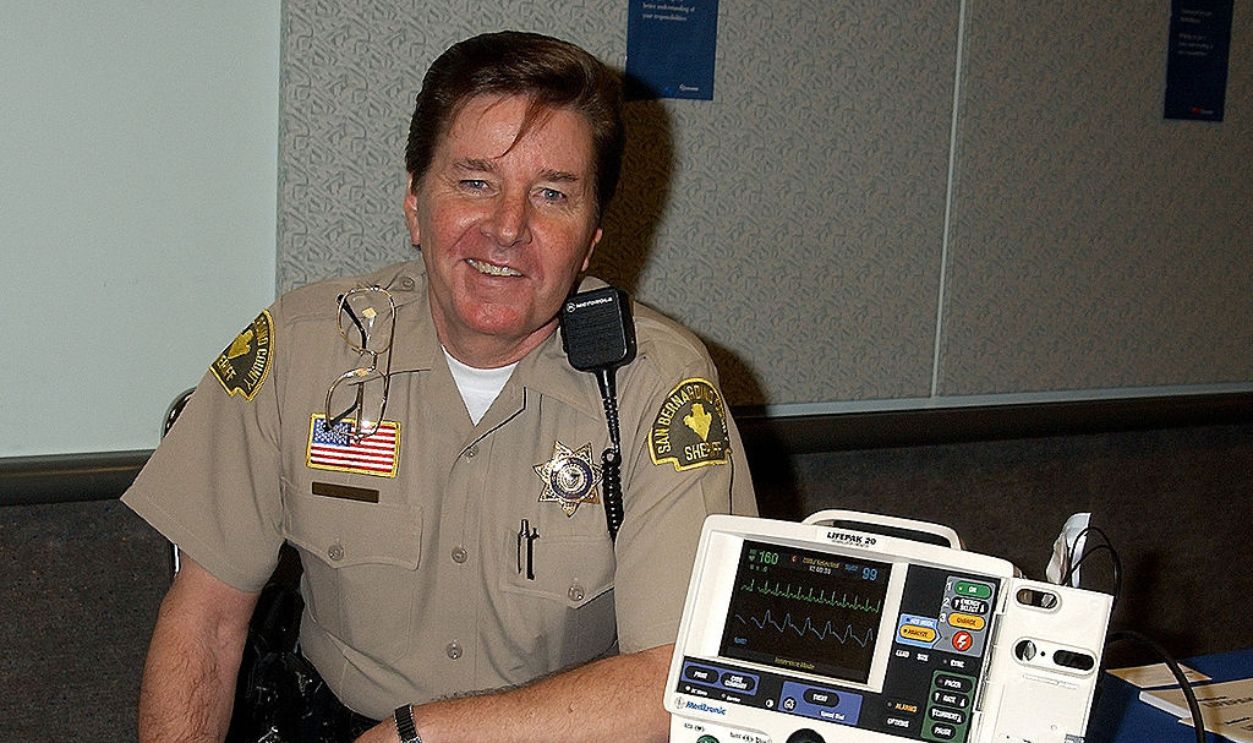 Bobby Sherman, the 1970s teen heartthrob, now a San Bernardino County deputy sheriff, who has also worked as a paramedic and a CPR trainer, holds a Life Pak 20 Defibrillator / Monitor.