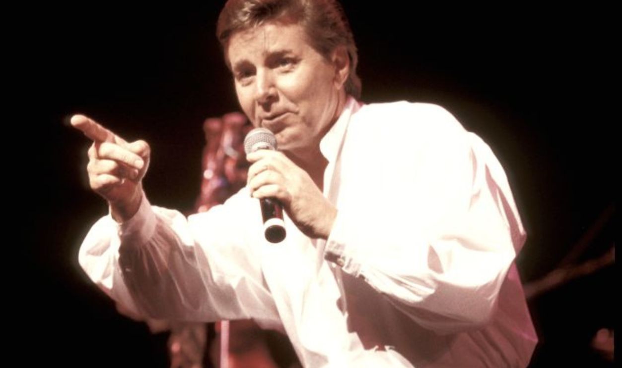 Singer and actor Bobby Sherman, who became a popular teen idol in the late 1960s and early 1970s, is shown performing on stage during a