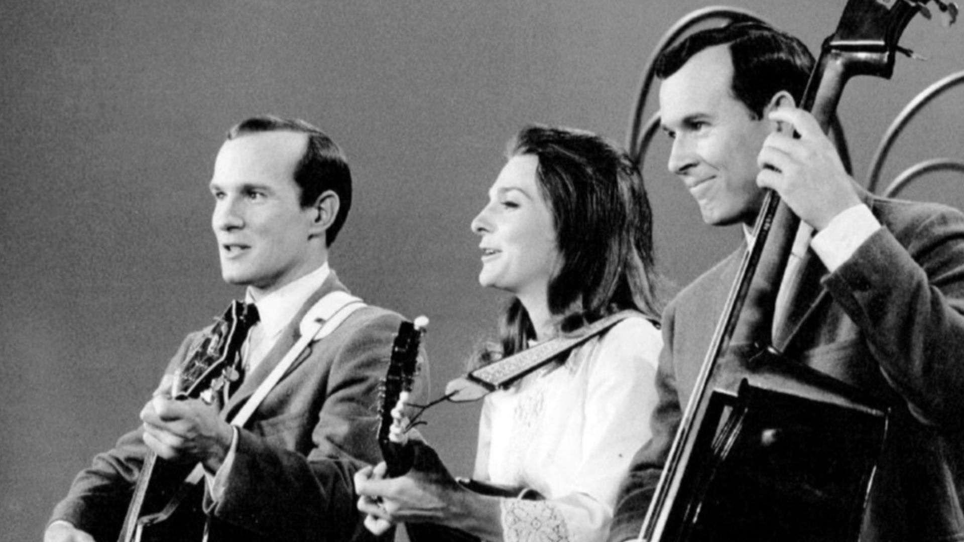 Photo of Judy Collins performing with Tom (left) and Dick Smothers on their television program The Smothers Brothers Comedy Hour.