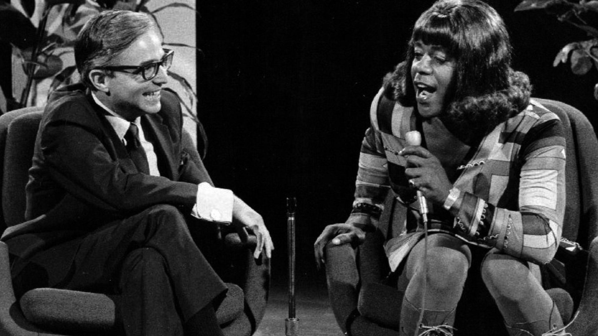 Publicity photo of Flip Wilson as Geraldine Jones from the television program The Flip Wilson Show.  Geraldine is interviewing Dr. David Reuben.