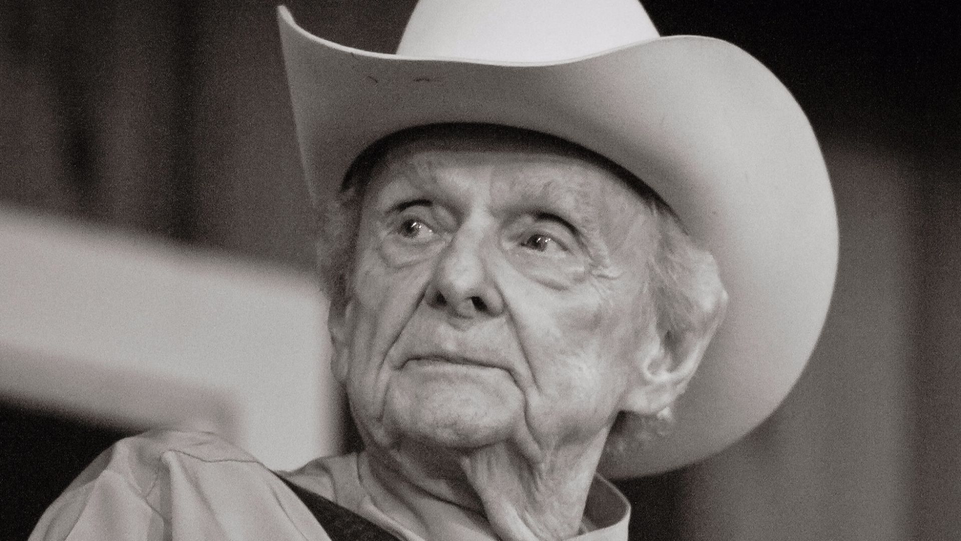 Image of Dr. Ralph Stanley taken by Reed George.  Photo was taken during Stanley's  appearance with his band, The Clinch Mountain Boys, at the 2011 Watermelon Park Festival in Berryville, VA.
Image has been cropped, noise digitally removed, and lighting c