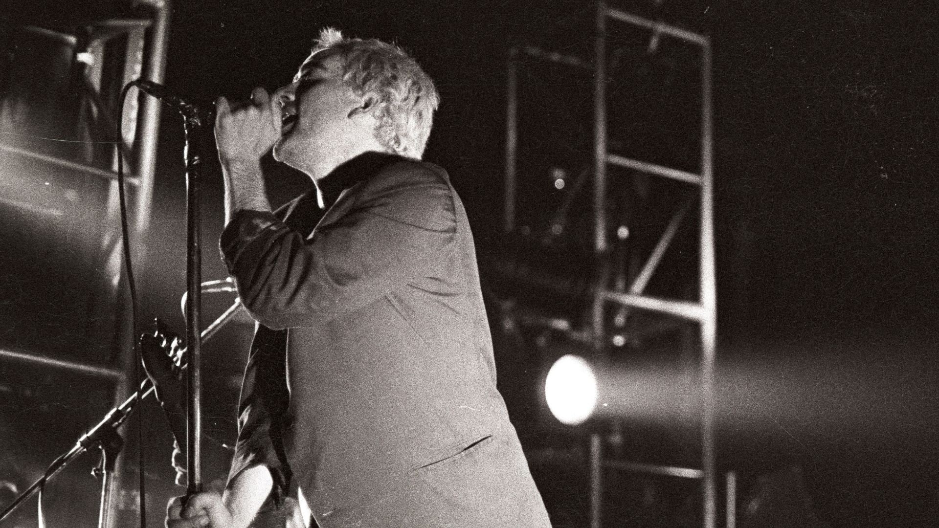 Michael Stipe (left) and Peter Buck (right) on stage in Ghent, Belgium, during R.E.M.'s 1985 tour.