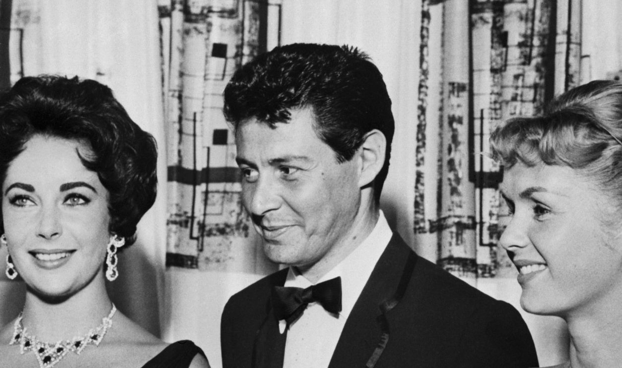 Eddie Fisher, Debbie Reynolds and Elizabeth Taylor (Original Caption) Singer Eddie Fisher is shown with his wife, Debbie Reynolds(right), and Elizabeth Taylor, when he opened his last engagement at the Tropicana Hotel here.