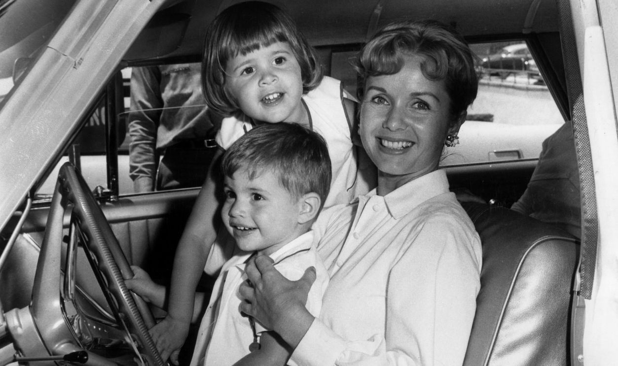 Debbie, Todd & Carrie 25th June 1960: American actor Debbie Reynolds smiles while sitting in the front seat of an automobile with her children Todd and Carrie Fisher, Hollywood, California. Reynolds was attending a rehearsal for the Boy's Club of Hollywood Benefit Performance at the Hollywood Bowl.
