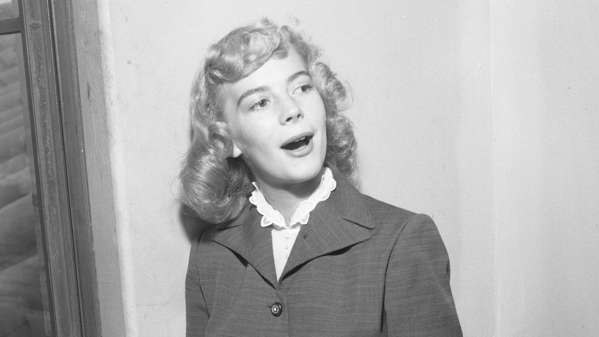 Actress Natalie Wood with blond hair at age 16 reviewing contract approval in Los Angeles