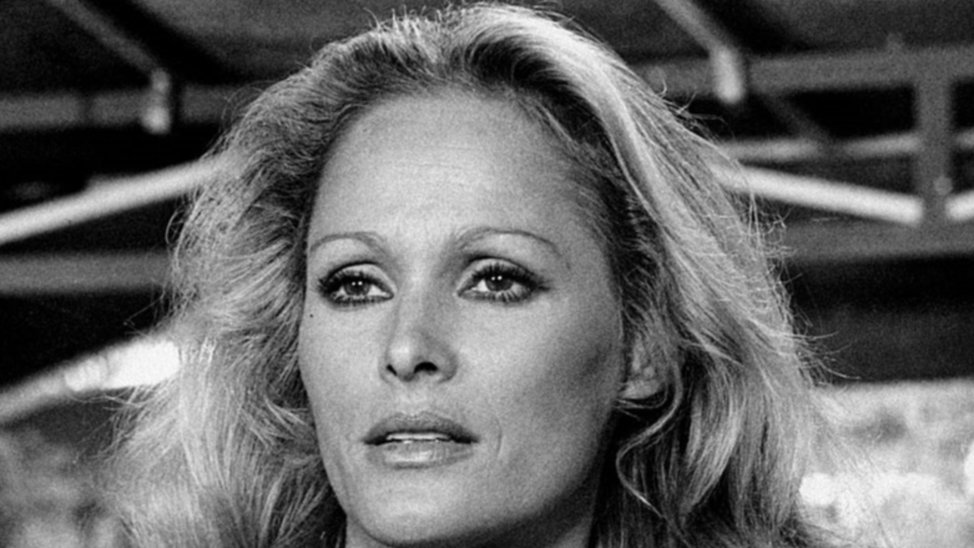 Close-up of Ursula Andress in a scene from the movie Stick'em Up, Darlings, starring the actress as the American hostess Nora Green. Italy, 1974