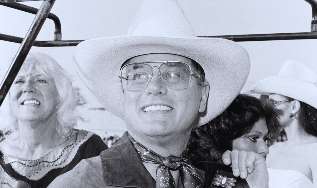 Gettyimages - 1759633787, 1982 Cattle Baron's Ball Benefit Larry Hagman (C) attends a party, benefitting the American Cancer Society, at the Cloyce Box Ranch in Frisco, Texas, on June 15, 1982.